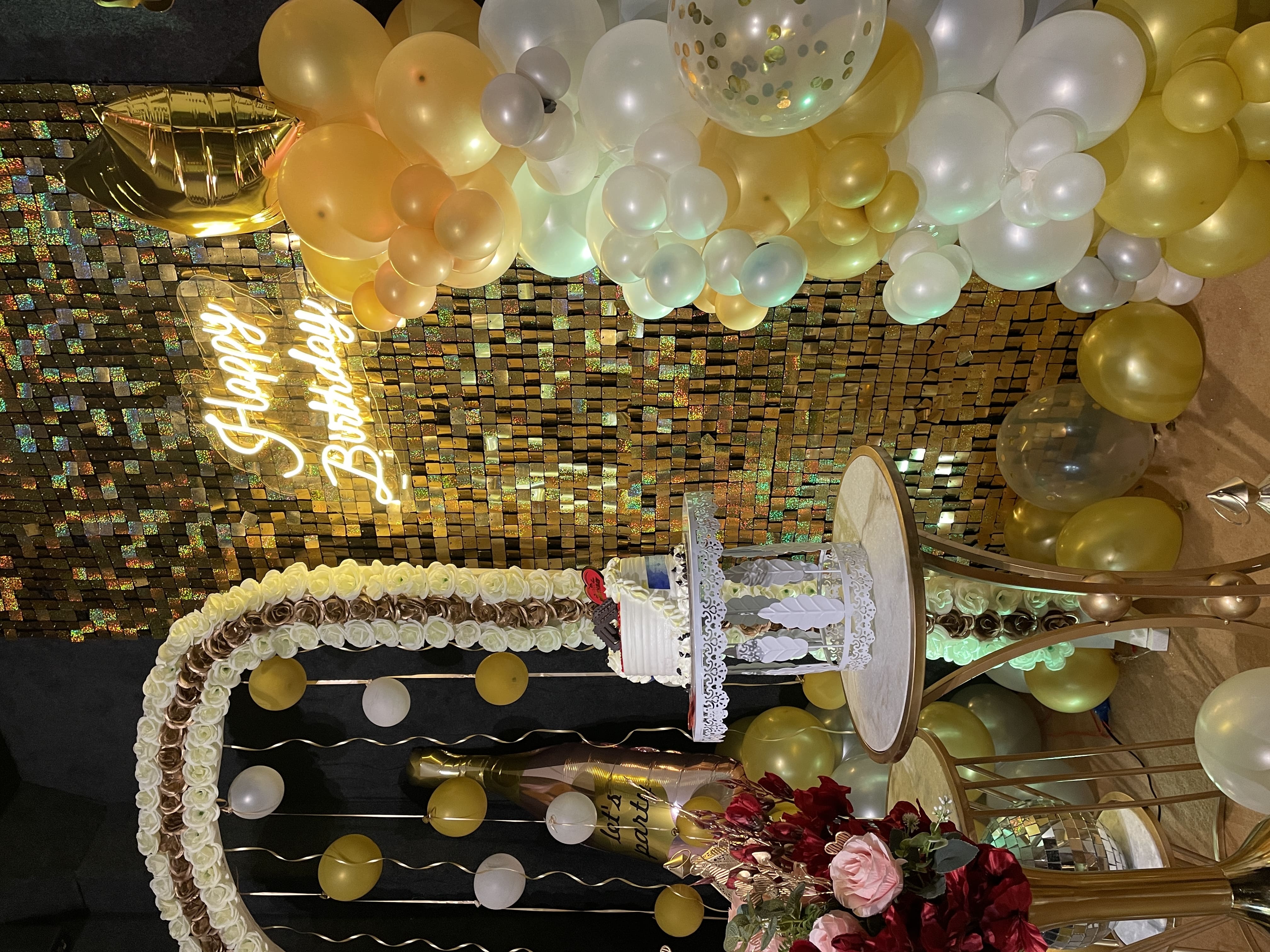 A person decorating a cake with pink frosting